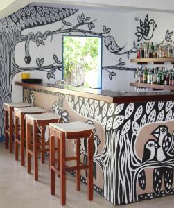 a restaurant with a black and white patterned wall at Pousada Xuê in Pôrto de Pedras
