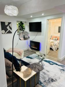 a living room with a couch and a table at Hertford Home detached garden parking pet allowed in Hertford