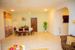 a living room with a table and a dining room at Malkiya House in Zanzibar City