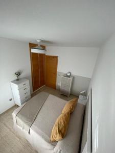 a bedroom with a bed and a dresser in it at Luxury Homes Toyo Golf Paradise Retamar in Retamar