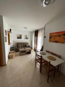 a living room with a couch and a table at Luxury Homes Toyo Golf Paradise Retamar in Retamar