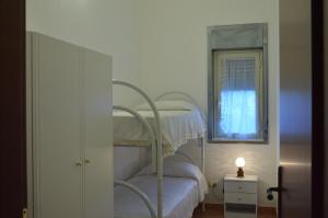 a bedroom with a bunk bed with a window at Sovareto Mare in Sciacca