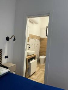 a bathroom with a sink and a toilet in a room at B&B Borgo Storico dei Marinai in Cirò Marina