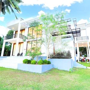 a white house with plants in front of it at Tranquil Heaven Near Galle & Unawatuna Quiet Stay & Fast WiFi in Galle +58 photos