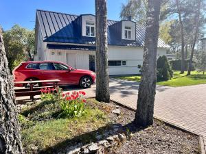 a red car parked in front of a house at White House apartment in Tallinn