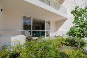 an external view of a house with a glass balcony at Akumal LuumHa Private Hot tub 7 Rooftop Pools Beach Access in Akumal +40 photos