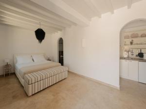 a white bedroom with a bed and a couch at VERANNA Patmos Studio1 in Patmos