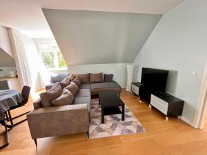 a living room with a couch and a flat screen tv at White House apartment in Tallinn