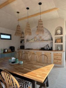 a kitchen with a wooden table and chairs at Muse 2Mai in 2 Mai