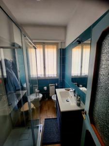 a bathroom with a sink and a glass shower at Maja in Chiavari +6 photos