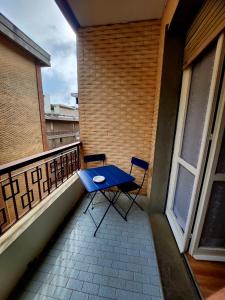 a blue table and two chairs on a balcony at Maja in Chiavari