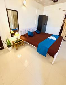 a bedroom with a large bed in a room at Upaja Ghar Homestay in Guwahati