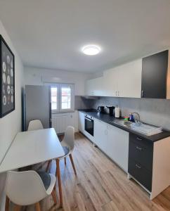 a kitchen with a table and chairs in a room at Residence Apartments in Bietigheim-Bissingen