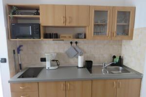 a kitchen counter with a sink and a microwave at Erika Medulin in Medulin +30 photos