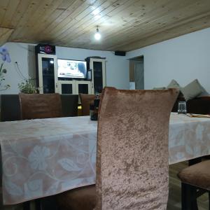 a dining room with a table and a tv at Bujtina Sherifaj in Valbonë +37 photos