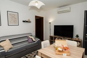 a living room with a couch and a table at Appartment - Joile Maisone in Porto Torres