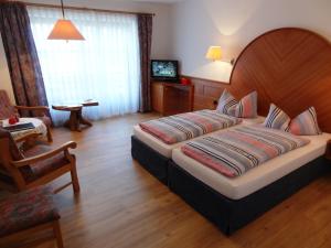 a bedroom with a large bed in a room at Hotel Müggelturm in Oberstdorf