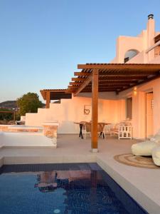 a villa with a swimming pool and a house at thEros - apartment 2 in Parikia