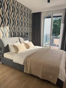 Ένα ή περισσότερα κρεβάτια σε δωμάτιο στο Apartament Centro z bezpłatnym garażem