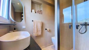 a bathroom with a sink and a shower with a mirror at Cannes Croisette in Cannes