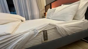 a white bed with white sheets and pillows at Legoland-JB Medini Luxury Play & Stay 5pax in Iskandar Puteri +12 photos