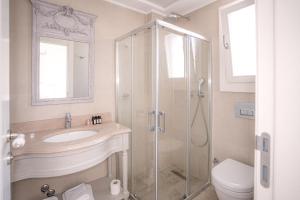 a bathroom with a shower and a sink and a toilet at Eritrina Alacati in Alacati