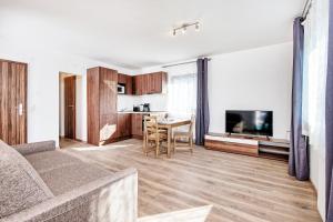 a living room with a couch and a dining room at Haus unter Gerlitzen in Bodensdorf