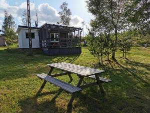 a picnic table in front of a cabin at Domek Rogalewo in Wiele