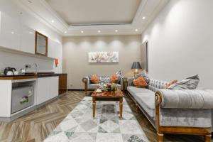 a living room with a couch and a table at Makeen Homes ApartHotel in Riyadh