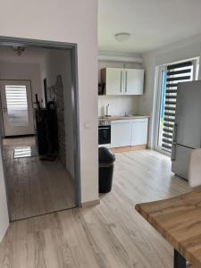 a kitchen with white cabinets and a refrigerator at Moderne Zimmer nähe A3 in Ransbach-Baumbach +7 photos