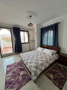 a bedroom with a large bed with a zebra blanket at Olea Azul in Chefchaouen
