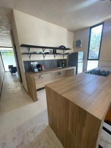 a kitchen with a wooden counter top in a room at Villa Colibries Chelem in Chelem