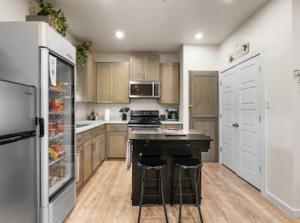 a kitchen with a stove and a refrigerator at The WorkNest Stylish Stay w Desk & Fast Wi-Fi in Laredo