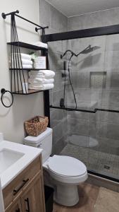 a bathroom with a shower and a toilet and a sink at The Miller's Retreat in Dothan +12 photos