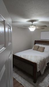 a bedroom with a bed with a ceiling fan at The Miller's Retreat in Dothan