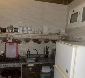 a kitchen counter with a sink and a refrigerator at Doody Cozy chalet in Dahab +3 photos