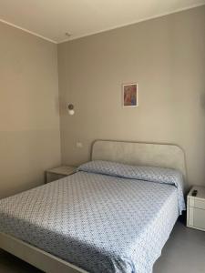 a bedroom with a bed with a blue comforter at NUOVO E CENTRALISSIMO in Civitanova Marche