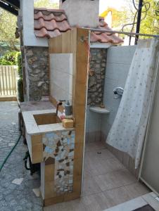 a bathroom with a sink and a shower at Apartmani Uvodić in Rogoznica +48 photos
