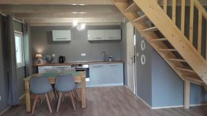 a kitchen with a table and chairs and a staircase at Paloma in Kołczewo