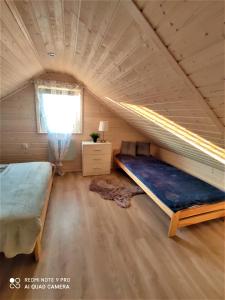 a room with a bed and a window in a attic at Paloma in Kołczewo