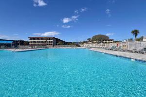 una grande piscina di acqua blu di fronte a un edificio di Turtles & Dolphins & Crabs, Oh My! a Hilton Head Island