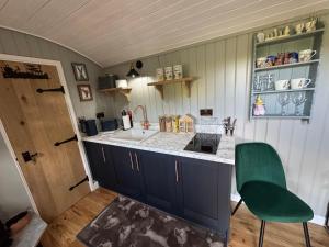 a kitchen with a sink and a counter top at Forest view shepherds hut Hare hut in Ewhurst