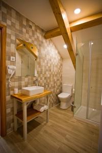 a bathroom with a sink and a shower and a toilet at Guest House 10 de Agosto in Figueira da Foz +61 photos
