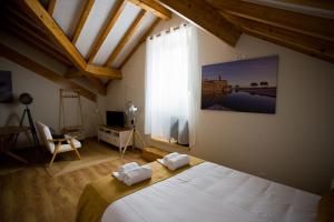 a bedroom with a bed and a large window at Guest House 10 de Agosto in Figueira da Foz