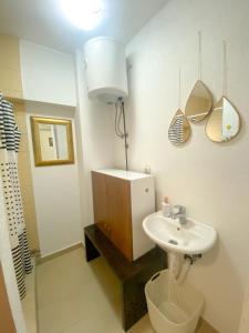 a bathroom with a sink and a toilet at Secret Garden Mostar in Mostar