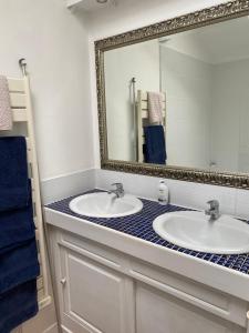 ein Badezimmer mit zwei Waschbecken und einem großen Spiegel in der Unterkunft Le Cordonnier d'Autrefois - 15 minutes du Puy du Fou in Mortagne-sur-Sèvre + 89 Fotos