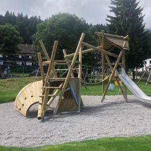 a playground with two swings and a slide at Bergblick Buchenhöhe in Berchtesgaden