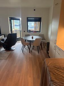 a living room with a table and chairs in a room at Nordtoppen in Alta +7 photos