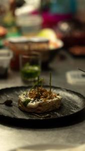 a piece of food on a plate on a table at Habitaciones Santa María Magdalena in Moncófar