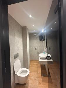 a bathroom with a toilet and a sink at Mare Beach Apartments in Stavros +19 photos